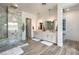 Bright and spacious bathroom featuring a marble walk-in shower and dual vanities with modern fixtures at 11238 Rebel Dome Ct, Las Vegas, NV 89141