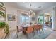 Dining area with an elegant light fixture and sliding glass doors leading to outdoor patio at 11238 Rebel Dome Ct, Las Vegas, NV 89141