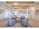 Cozy living room with beamed ceilings, a wine rack, and comfortable seating arrangement at 11238 Rebel Dome Ct, Las Vegas, NV 89141