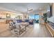 Open-concept living room with a large sectional, fireplace, and sliding glass doors to the patio at 11238 Rebel Dome Ct, Las Vegas, NV 89141