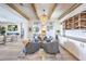 Spacious living area with a fireplace, wood floors, and an open layout with a bar at 11238 Rebel Dome Ct, Las Vegas, NV 89141