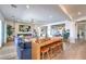 Stylish living room featuring an open floor plan, a bar with stools, and hardwood floors at 11238 Rebel Dome Ct, Las Vegas, NV 89141