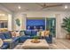 Inviting living room with plush blue sectional and views of the backyard pool at 11238 Rebel Dome Ct, Las Vegas, NV 89141