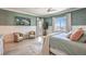 Inviting bedroom with a view, comfortable seating, and a soothing color scheme at 11238 Rebel Dome Ct, Las Vegas, NV 89141