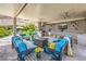 Inviting outdoor kitchen and dining area with a large ceiling fan at 11238 Rebel Dome Ct, Las Vegas, NV 89141