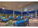 Luxurious covered patio with comfortable seating, ceiling fans, and outdoor dining overlooking a serene pool at 11238 Rebel Dome Ct, Las Vegas, NV 89141