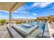 Luxury pool featuring a spa, rock waterfall, and covered patio, perfect for outdoor relaxation at 11238 Rebel Dome Ct, Las Vegas, NV 89141