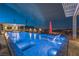 Backyard pool area featuring a stunning pool, waterfall features, fire bowls, and comfortable lounging spaces at 11238 Rebel Dome Ct, Las Vegas, NV 89141