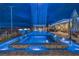 Striking backyard pool featuring a waterfall feature, adjacent spa, and well-appointed outdoor seating area with fire bowls at 11238 Rebel Dome Ct, Las Vegas, NV 89141
