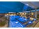 Beautiful pool and spa with water feature, creating a luxurious and relaxing backyard oasis at twilight at 11238 Rebel Dome Ct, Las Vegas, NV 89141