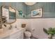 Stylish powder room features a turquoise color scheme and lovely decor at 11238 Rebel Dome Ct, Las Vegas, NV 89141