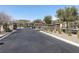 View of the community entrance with stone features and well-maintained landscaping at 12243 Pacific Cruise Ave, Las Vegas, NV 89138