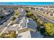 Aerial view of a home with solar panels, desert landscaping, close to roadways, in a suburban neighborhood at 1610 Dire Wolf Avenue, North Las Vegas, NV 89084