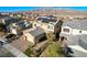 Aerial view of a two-story home with solar panels, desert landscaping, and a brick driveway at 1610 Dire Wolf Avenue, North Las Vegas, NV 89084