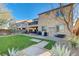 The backyard features manicured grass, desert landscaping, and a patio, perfect for outdoor entertaining and relaxation at 1610 Dire Wolf Avenue, North Las Vegas, NV 89084