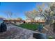 Landscaped backyard with lush grass, brick pavers, desert plants and patio furniture at 1610 Dire Wolf Avenue, North Las Vegas, NV 89084