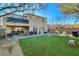 Spacious backyard with artificial turf, mature landscaping, and a patio offers an ideal outdoor living space at 1610 Dire Wolf Avenue, North Las Vegas, NV 89084