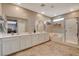 Bathroom showcasing double vanity, tub, and glass shower enclosure at 1610 Dire Wolf Avenue, North Las Vegas, NV 89084