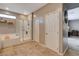 Bathroom exhibiting tub, glass shower, neutral color palette, and tile flooring at 1610 Dire Wolf Avenue, North Las Vegas, NV 89084