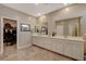 Bathroom highlighting double vanity, neutral color palette, tile flooring, and walk in closet at 1610 Dire Wolf Avenue, North Las Vegas, NV 89084