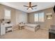 Bright bedroom features a tapestry wall hanging, ceiling fan and carpet at 1610 Dire Wolf Avenue, North Las Vegas, NV 89084