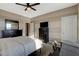 Comfortable bedroom featuring neutral paint, ceiling fan, and dark wood furniture at 1610 Dire Wolf Avenue, North Las Vegas, NV 89084
