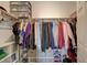 Walk-in closet with neatly organized clothing, shelving, and storage bins at 1610 Dire Wolf Avenue, North Las Vegas, NV 89084