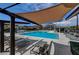 Inviting community pool with sunshades and lounge chairs for relaxation and leisure at 1610 Dire Wolf Avenue, North Las Vegas, NV 89084