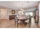 Dining area featuring hardwood floors, chandelier, and open access to the living room at 1610 Dire Wolf Avenue, North Las Vegas, NV 89084