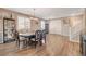 Elegant dining area with hardwood floors, a chandelier, and access to the stairway at 1610 Dire Wolf Avenue, North Las Vegas, NV 89084
