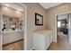 Hallway featuring a vanity with drawers, access to the bathroom and bedroom at 1610 Dire Wolf Avenue, North Las Vegas, NV 89084