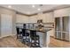 Bright kitchen featuring white cabinetry, a granite island with bar seating, and stainless appliances at 1610 Dire Wolf Avenue, North Las Vegas, NV 89084