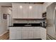 Bright kitchen featuring white cabinets, stainless steel appliances, and black countertops at 1610 Dire Wolf Avenue, North Las Vegas, NV 89084