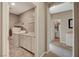 Laundry room featuring a washer, dryer, countertops, and white cabinetry at 1610 Dire Wolf Avenue, North Las Vegas, NV 89084