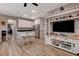 Open floor plan showcasing kitchen with stainless appliances and living room with entertainment center and decor at 1610 Dire Wolf Avenue, North Las Vegas, NV 89084