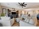 Comfortable living room with hardwood floors and neutral-toned furnishings, open to the dining area at 1610 Dire Wolf Avenue, North Las Vegas, NV 89084