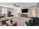 Spacious living room with a comfortable sectional, entertainment center, and a cozy atmosphere, perfect for relaxing at 1610 Dire Wolf Avenue, North Las Vegas, NV 89084
