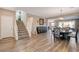 Inviting living room featuring hardwood floors and an open floor plan leading to the dining area at 1610 Dire Wolf Avenue, North Las Vegas, NV 89084