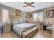 Comfortable primary bedroom with decorative art, wood-like floors, and large window at 1610 Dire Wolf Avenue, North Las Vegas, NV 89084