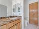 Neutral bathroom featuring a granite countertop, wood cabinets, and large cabinets at 1904 Bellview St, Las Vegas, NV 89134