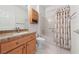 Neutral bathroom featuring a granite countertop, wood cabinets, and shower over tub at 1904 Bellview St, Las Vegas, NV 89134
