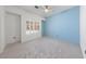 Bedroom with neutral carpet, a window with shutters, and light blue walls at 1904 Bellview St, Las Vegas, NV 89134