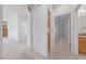 Hallway with carpet, white walls, and wood cabinets at 1904 Bellview St, Las Vegas, NV 89134