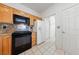 Charming kitchen with black appliances, tile floor, wooden cabinetry, and granite countertops at 1904 Bellview St, Las Vegas, NV 89134