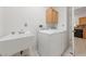 Laundry room featuring a sink, washer, dryer, and wood cabinet at 1904 Bellview St, Las Vegas, NV 89134