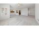Expansive living area showcasing tile flooring, light walls, and seamless flow to the adjacent dining area at 1904 Bellview St, Las Vegas, NV 89134