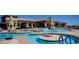 Attractive community pool with multiple seating areas, umbrellas, and mountain views at 1904 Bellview St, Las Vegas, NV 89134