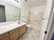 Clean bathroom with a vanity, toilet, and shower-tub combo, featuring neutral tones and tile flooring at 2064 Mesquite Ln # 102, Laughlin, NV 89029