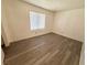 Bedroom featuring wood-look flooring, a window with blinds, and neutral walls, offering a calming space at 2064 Mesquite Ln # 102, Laughlin, NV 89029