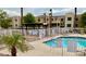 Community pool provides a refreshing oasis with seating and palm trees in a gated area at 2064 Mesquite Ln # 102, Laughlin, NV 89029